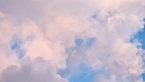 A serene sky scene featuring a patchwork of soft blue, pale pink, and grey .. Stock Photos