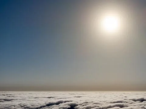 Serene sky view above the clouds with a bright sun illuminating the landscape Fotos de archivo