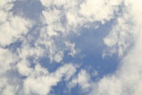 Serene Sky View Featuring Soft White Clouds Floating in Azure Blue Stock Photos