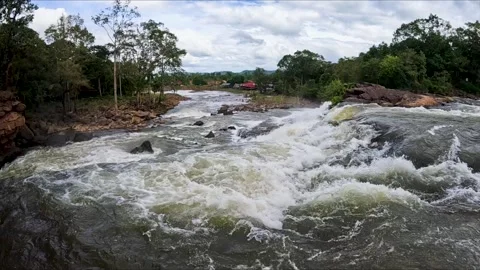 Serene Slow Motion Scenes of a Mighty River with Small Waterfalls 動画素材 240884214