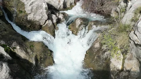 A Serene Stream Flowing Gently Over Rocky Terrain in the Heart of Natures Beauty Stock Footage 300474138