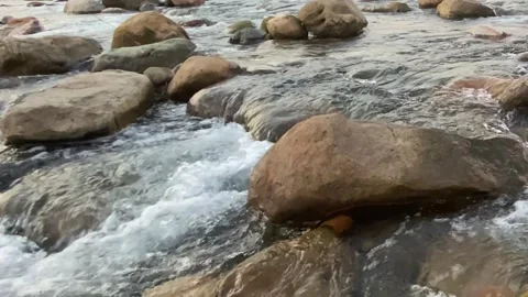 Serene stream flowing through smooth rocks in a peaceful nature, sylhet Stock-Footage 329538606