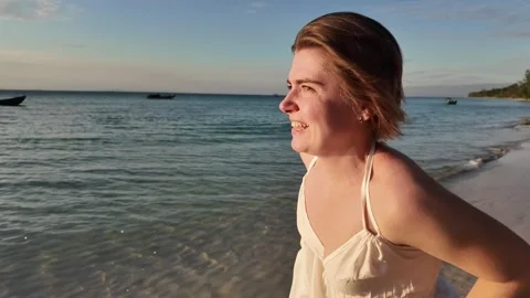 Serene Sunset Beach Bliss with Smiling Woman Stock Footage 263515604