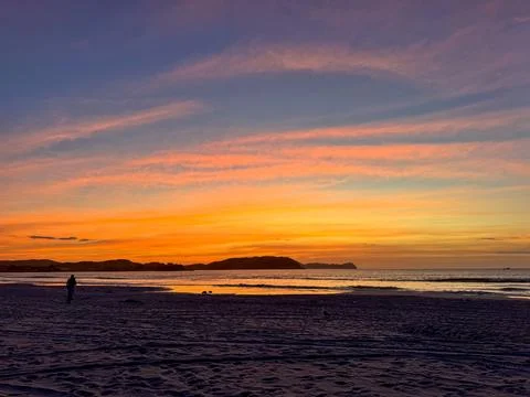 Serene sunset on the beach Stock Photos