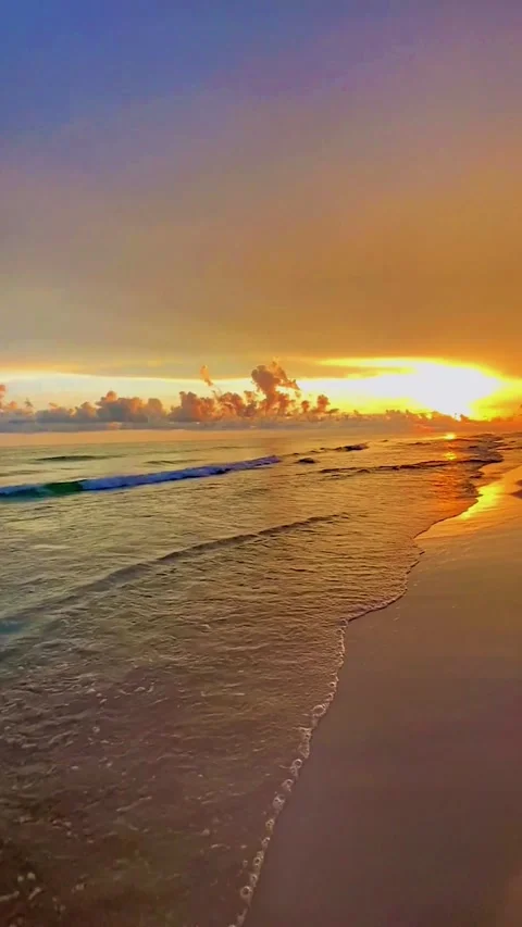 Serene Sunset Beach Scene with Gentle Waves and Vibrant Sky Stock Footage 342370585
