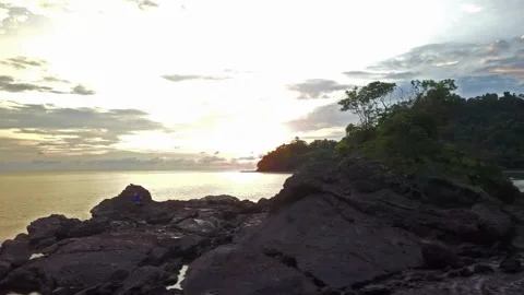 Serene Sunset over Coastal Cliffs and Calm Ocean Waters Stock Footage 310381159