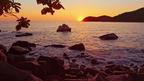 Serene Sunset Over Coastal Rocks and Calm Ocean Waters Stock Footage 301045583