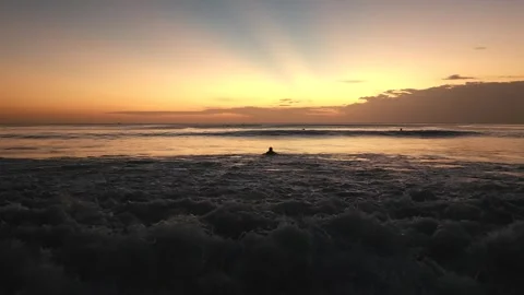 Serene Sunset Over Ocean with Surfer Silhouette at Dreamland Beach, Bali Stock Footage 340390992