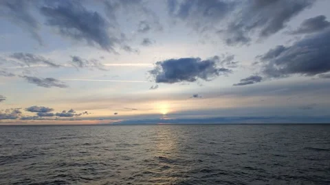 A Serene Sunset Over the Tranquil and Peaceful Sea, Painting the Sky Stock Footage 316221017