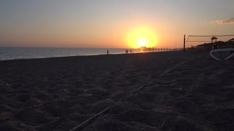 A Serene Sunset Over the Tranquil Beach: Witness the Radiant Sky Gradually Stock Footage 317906545