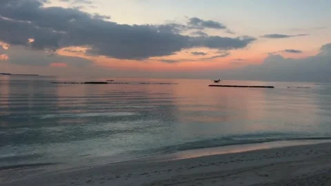 Serene sunset over tranquil ocean with seaplane landing Stock Footage 302307335