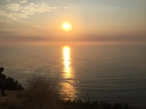 Serene Sunset Over a Tranquil Ocean Reflecting Golden Hues Stock Photos