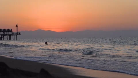 A Serene Sunset Over Tranquil Waters: Capturing the Beauty of Evening by the Stock Footage 317906221