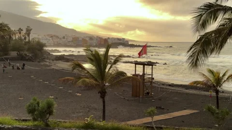 Serene Sunset at Playa de Castillo, Tenerife with a Red Flag Warning Stock Footage 330898068