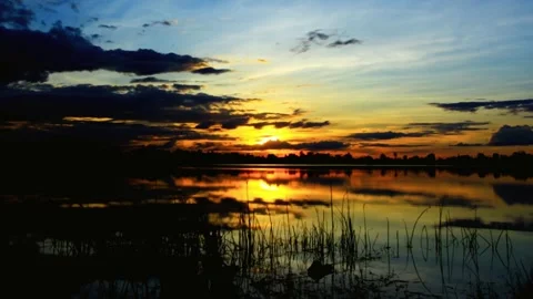 Serene Sunset Reflection over Calm Lake Waters 스톡 동영상 311586699