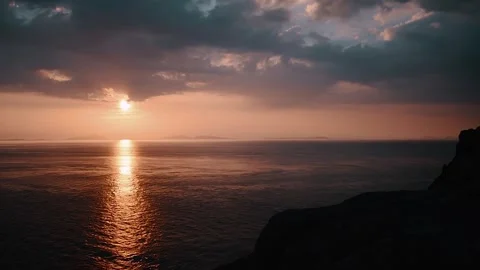 Serene Sunset Reflection Over Calm Ocean Waters in 4K UHD Stock Footage 323836219