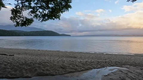 Serene Sunset Reflections at Lake Te Anau: A Scenic Great Walk in Fiordland.. Stock Footage 295242479