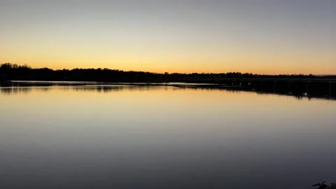 Serene Sunset Reflections Over Calm Water Stock Footage 291987154