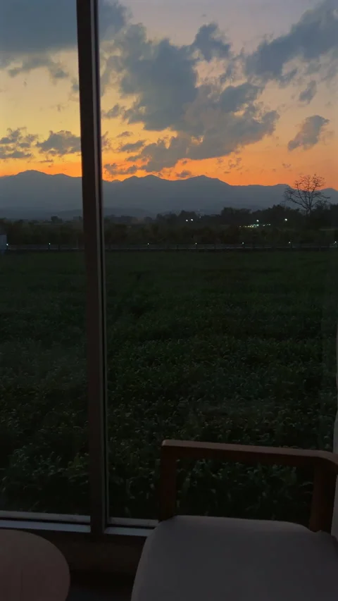 Serene sunset view from cozy room with comfortable chair and side Video stock 274935563