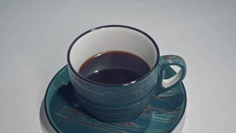Serene Symphony: A Cup of Coffee Dancing on a Saucer Stock Footage 278906281