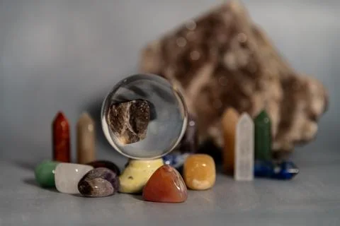 A serene tarot setup featuring a geode, assorted crystals, and a candle holde Stock Photos