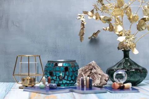 A serene tarot setup featuring a geode, assorted crystals, and a candle holde Stock Photos