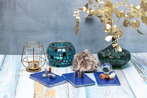 A serene tarot setup featuring a geode, assorted crystals, and a candle holde Stock Photos