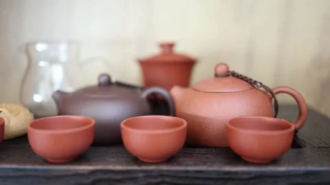 A serene tea ceremony setup with traditional Yixing clay teapots and cups on a w Stock Footage 304623388