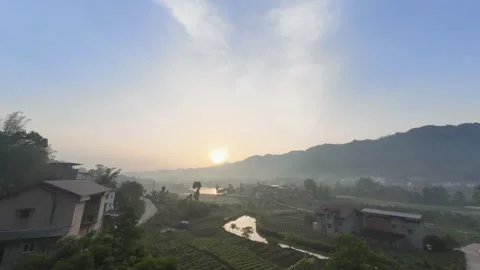 Serene time‑lapse of sunrise over quiet Chinese rural countryside landscape Stock Footage 344829455