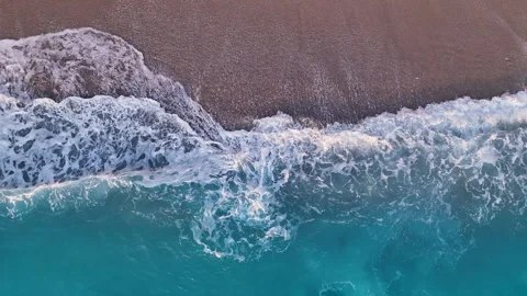 Serene Turquoise Wave Rolling onto a Sandy Shore 4K Stock Footage 315506488