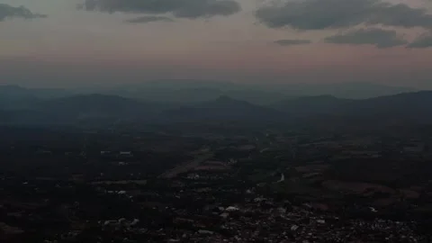 A serene twilight panorama of mountains with a gradient sky, featuring a village 動画素材 308595645