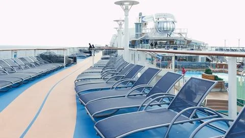 A serene view of blue deck chairs perfectly arranged in neat rows on a luxu.. Stock Photos