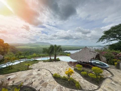 Serene view of infinity pool and lush landscape during sunset in tropical r.. Stock Photos