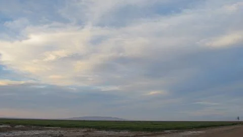 Serene view of an open plain at sunset, highlighting stock photo. Stock Photos