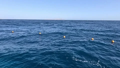 A Serene View of the Open Sea with Floating Markers, Capturing the Calmness and 库存影片 330101514
