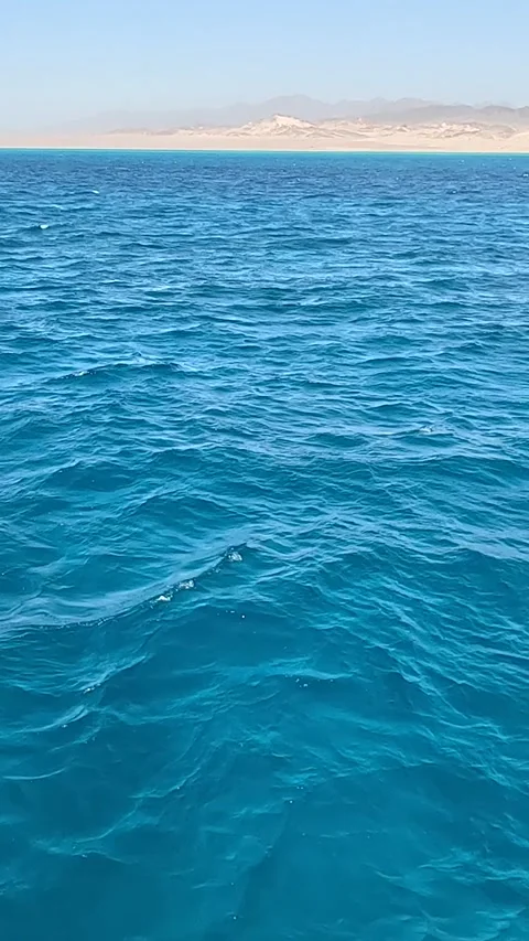 A Serene View Over Crystal Clear Ocean Waters With a Distant Shoreline of Softly Stock Footage 331277997