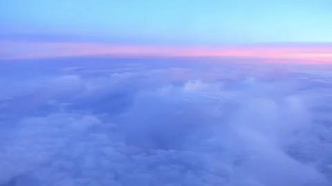 A serene view of pink-tinged clouds during sunset seen from above with soft.. Stock Footage 286259433