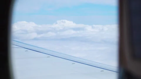 Serene View From Plane Window, Featuring Aircraft Wing Against Backdrop of Stock Footage 303372889