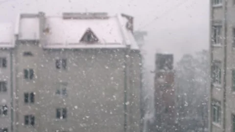 A serene view of snowflakes falling on a charming building, capturing the Stock Footage 306158603