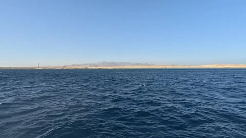 A Serene View of Tranquil Waters with Gentle Waves and a Distant Coastal Video stock 331058387