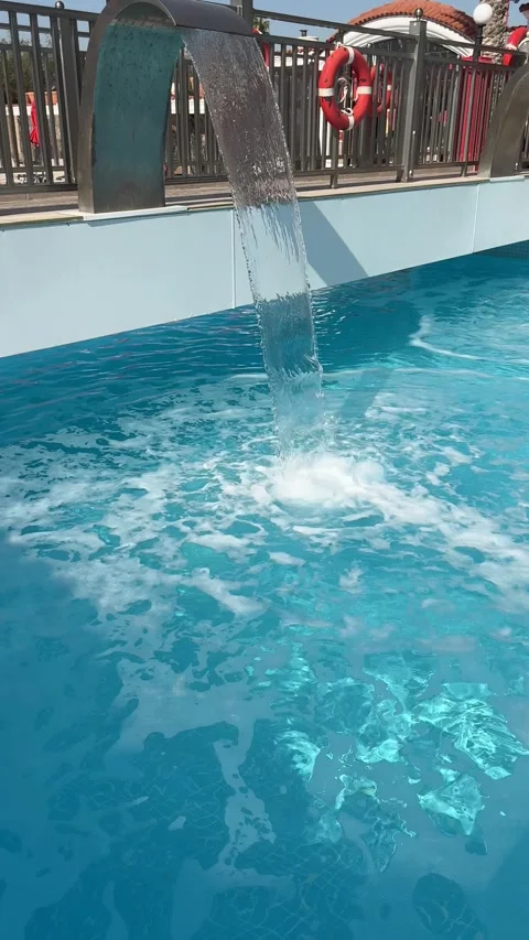 A serene waterfall cascades into a tranquil pool, creating a soothing ambianc Video stock 305389192