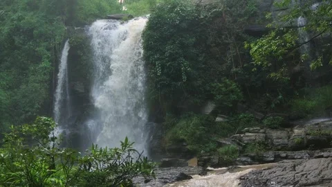 A Serene Waterfall Flowing Gracefully, Beautifully Surrounded by Lush Greenery. Stock Footage 302263863