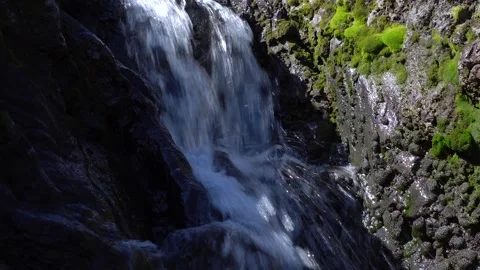 A Serene Waterfall Gracefully Cascading Down Through Rugged Rocky Terrain and Stock-Footage 291170965