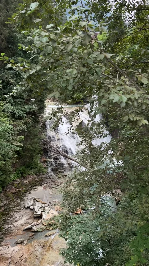 A Serene Waterfall So Beautifully Hidden Among Lush Greenery in Natures Embrace Stock Footage 292803954