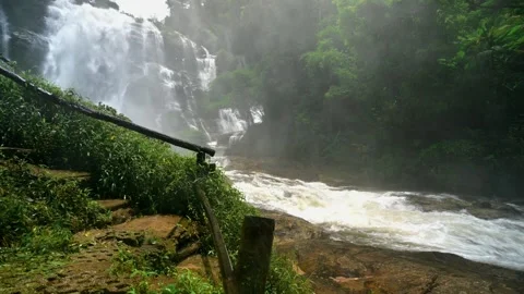 Serene Waterfall Surrounded by Lush Greenery in Chiang Mai Stock Footage 315491413