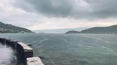 The serene waters gently flow under the vast and cloudy skies, creating a Stock Footage 319591065