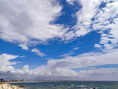 A serene, wideangle view of a dramatic blue sky filled with fluffy white clou 写真素材