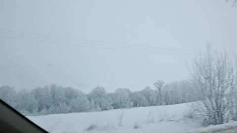 A Serene Winter Landscape Featuring Heavy Snowfall and a Still, Peaceful Stock Footage 305514451