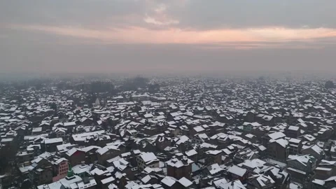 Serene winter landscape featuring Kashmiri architecture under fresh snow Stock Footage 310224670