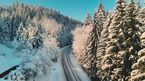 Serene Winter Landscape Featuring Winding Mountain Road And Sunrise Stock Footage 323572199
